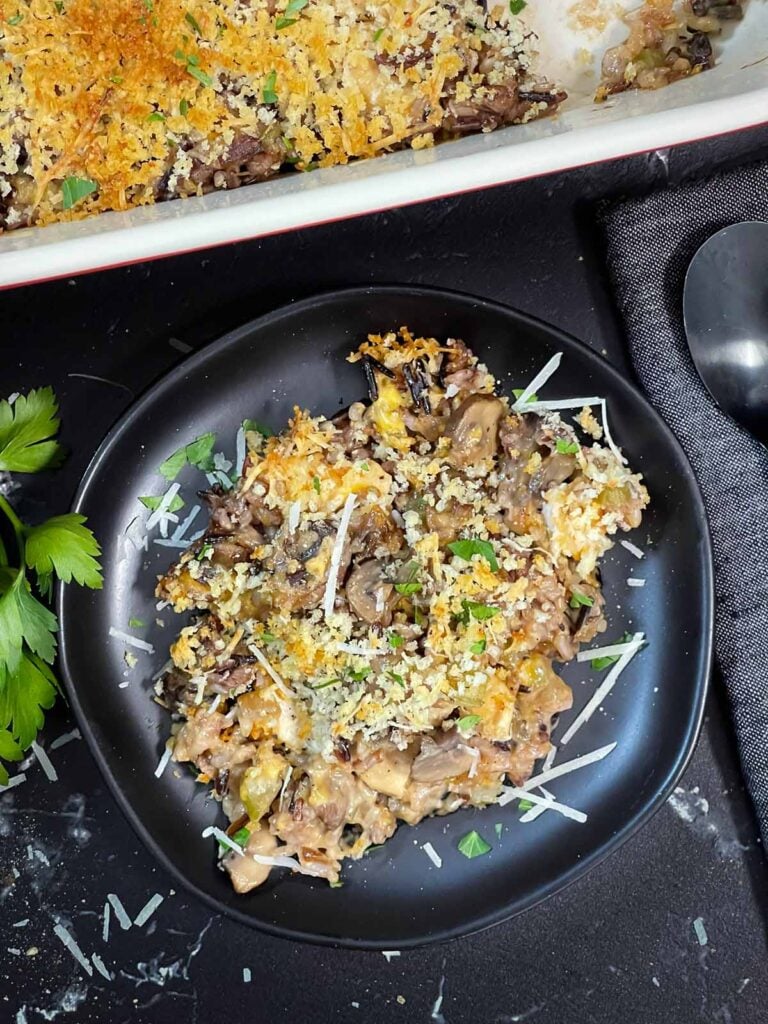 Chicken and wild rice casserole on a dark plate.