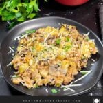 Chicken and wild rice casserole on a dark plate.