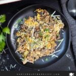 Chicken and wild rice casserole on a dark plate.