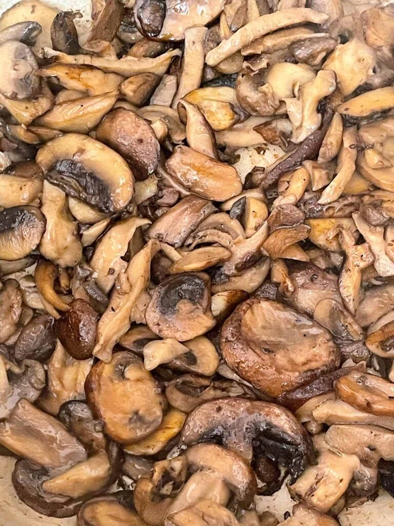 Cooked mushrooms in a Dutch oven for the mushroom barley soup recipe.
