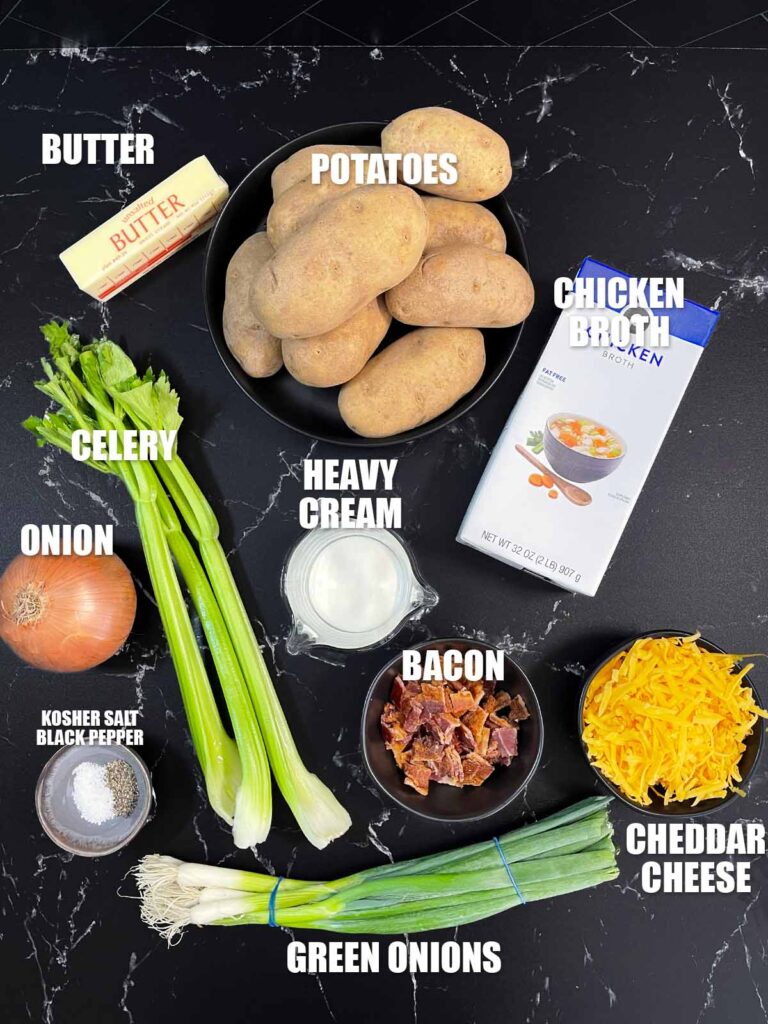 Creamy potato soup recipe ingredients on a dark surface.