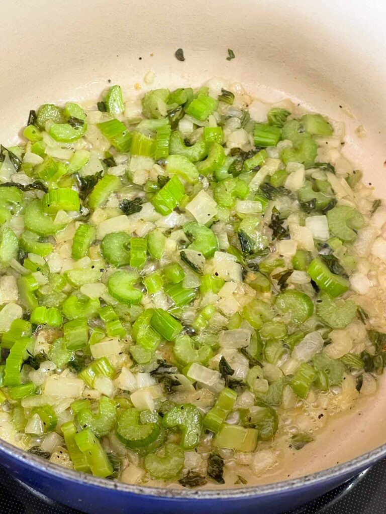 Celery and onions sauteed in a large Dutch oven.