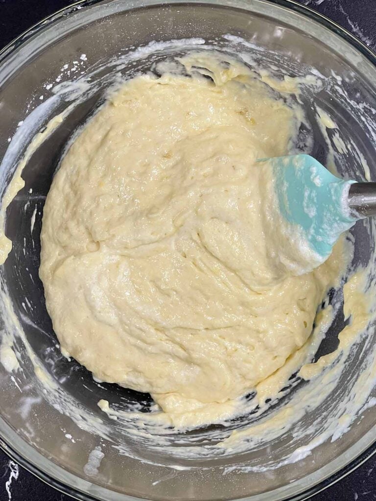 Folding whipped egg whites into batter for a light and airy texture.