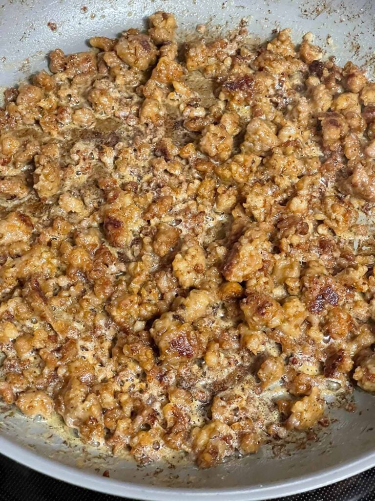 The beginnings of a sausage gravy in a skillet.