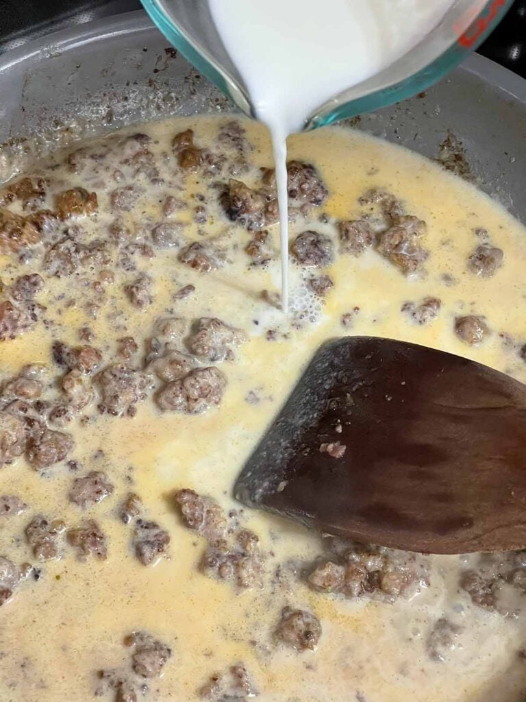 Sausage gravy being made in a skillet.