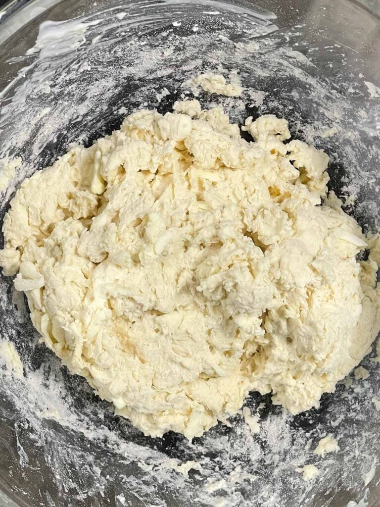 Biscuit dough in a glass bowl.