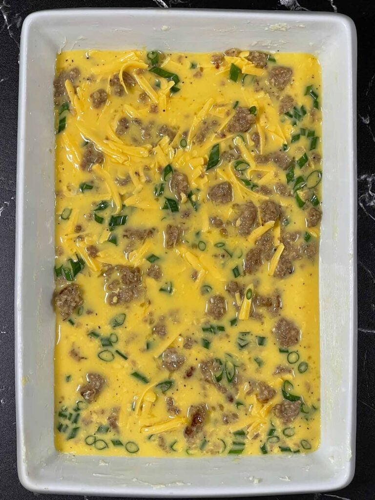 Sausage egg mixture in a 9x13 casserole dish.