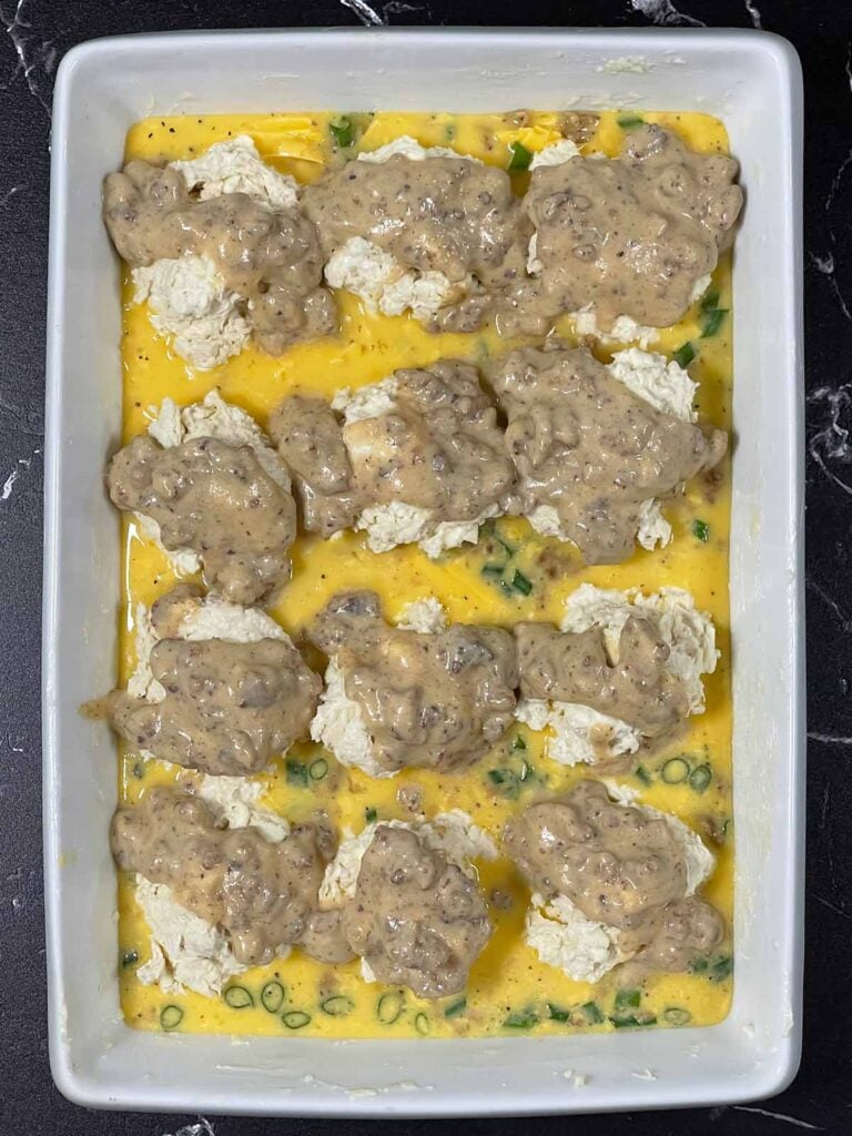 Drop biscuits topped with gravy ready to go into the oven.