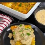 A serving of biscuits and gravy breakfast casserole on a dark plate.