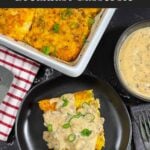 A serving of biscuits and gravy breakfast casserole on a dark plate.