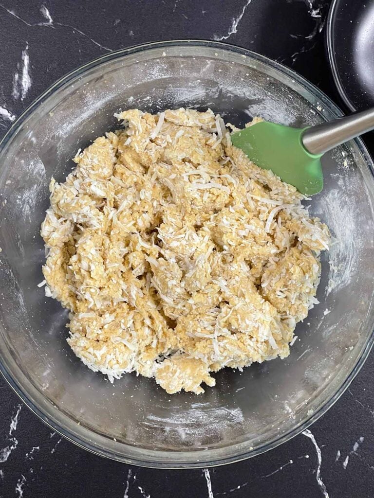 Shredded coconut folded into cookie dough.