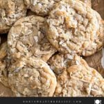 Soft and chewy coconut cookies stacked on parchment paper.