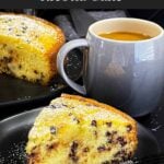 A slice of chocolate chip ricotta cake garnished with powdered sugar on a dark plate.