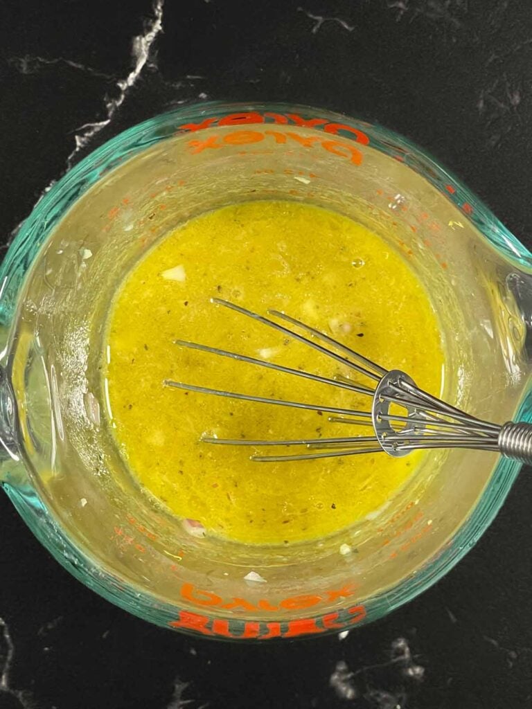 Whisking lemon dill vinaigrette for green bean potato salad.