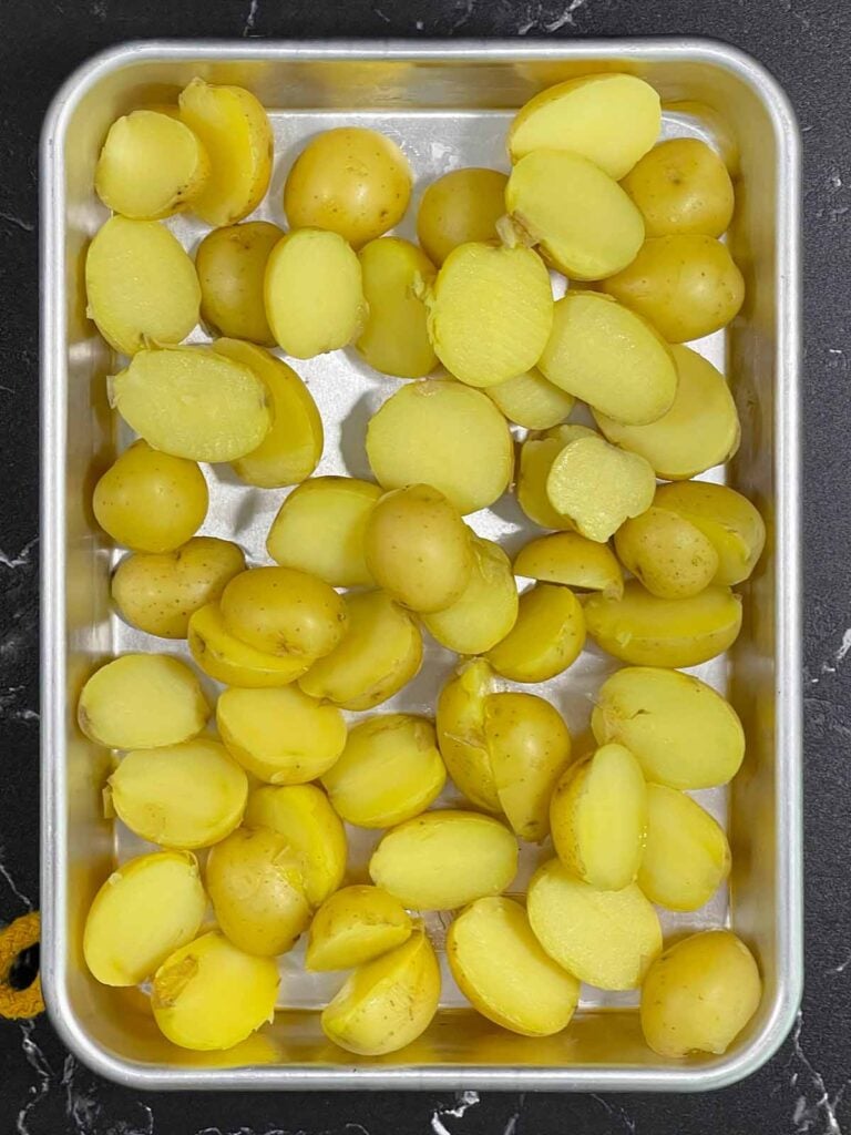 Baby Yukon Gold potatoes sliced in half.