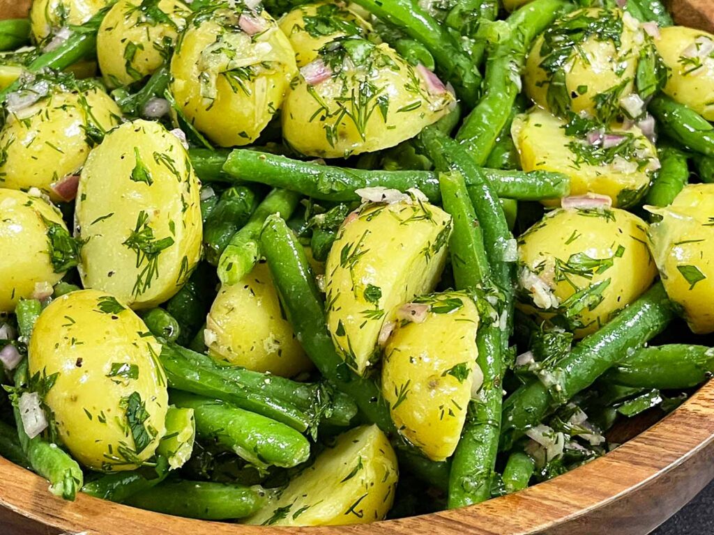 Close up of green bean potato salad with fresh dill.