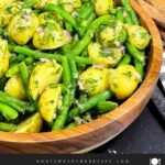 Lemon dill potato salad with green beans in serving bowl.