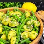 Green bean potato salad with lemon dill vinaigrette in a wooden bowl.