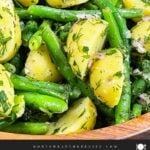 Green bean potato salad with lemon dill vinaigrette in a wooden bowl.