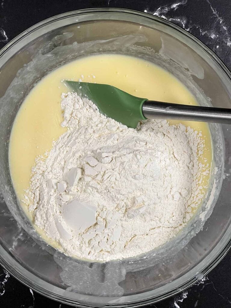 Dry ingredients added to the wet ingredients for the lemon muffins.