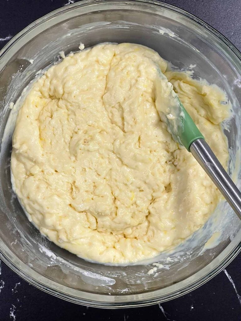 Thick lemon muffin batter after resting before baking.