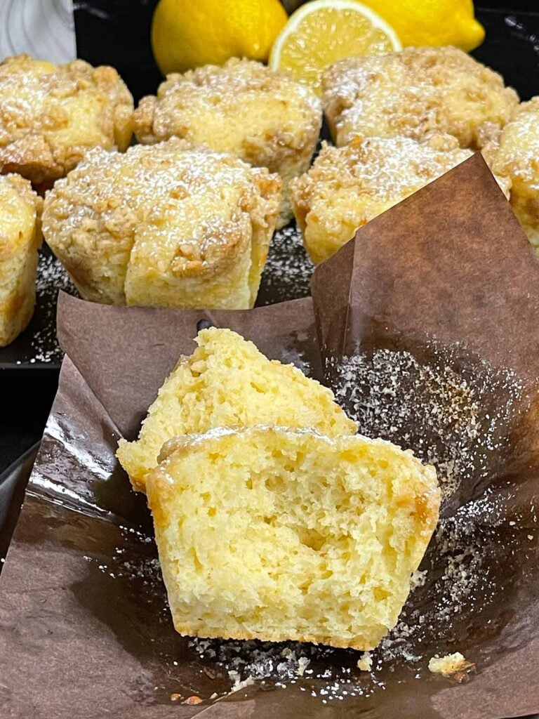 Close-up of a lemon crumb muffin showing the soft, moist interior and tender crumb.