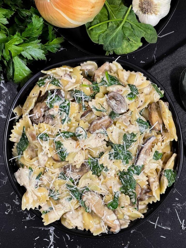 Spinach and Mushroom Pasta in a dark bowl.