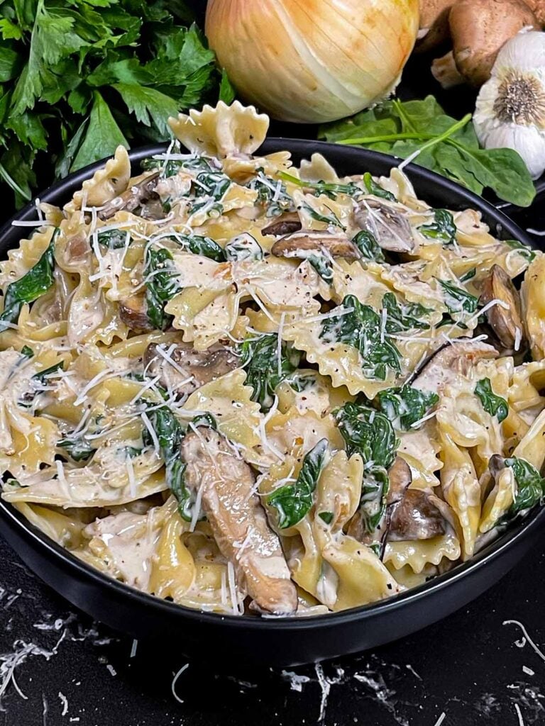 Spinach and Mushroom Pasta in a dark bowl.