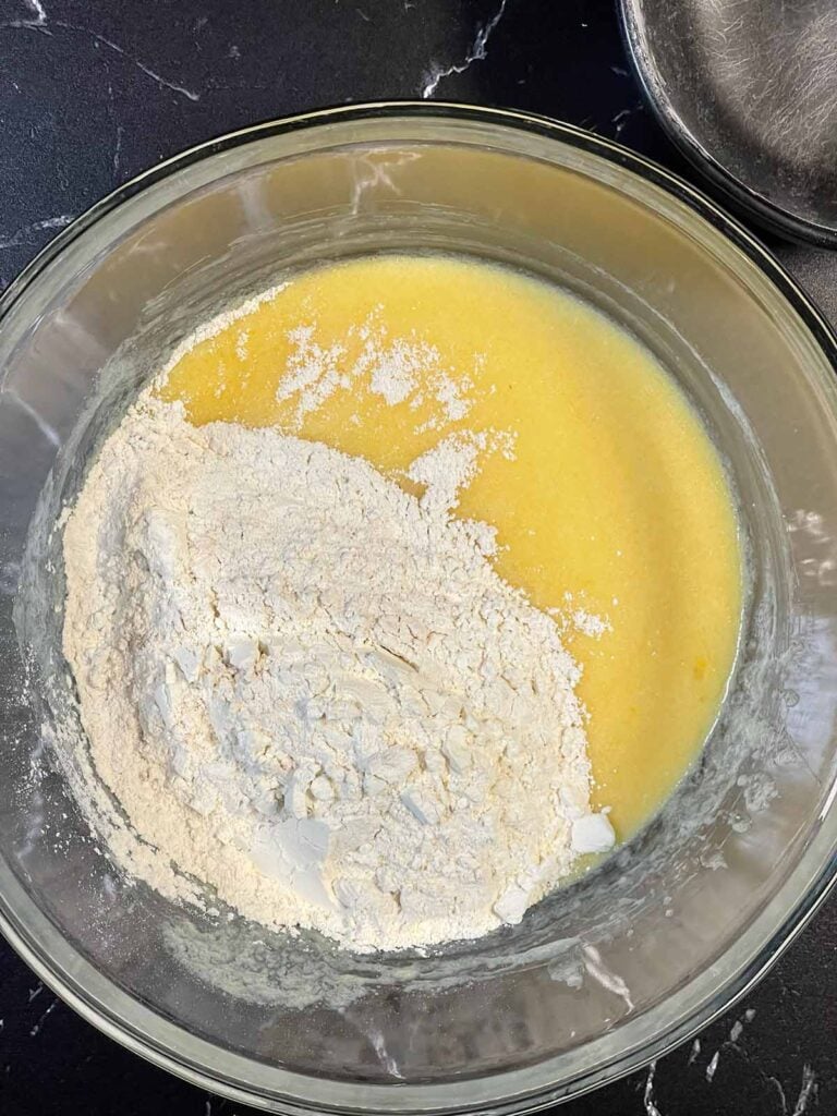 Dry ingredients added to wet ingredients in a large bowl.