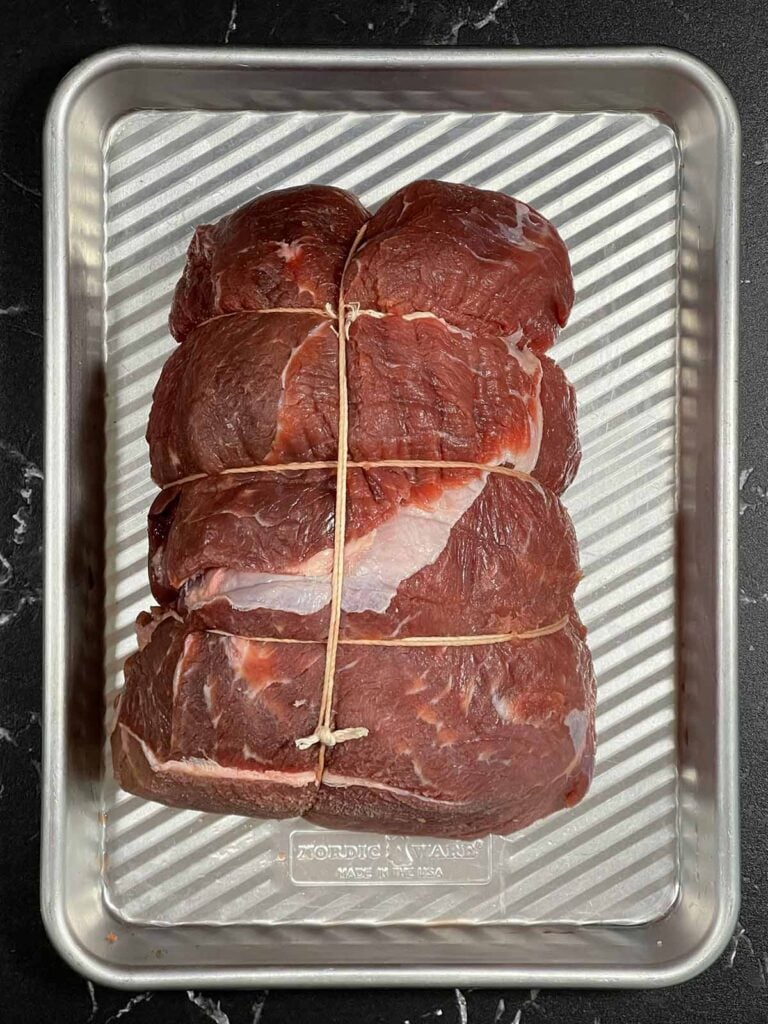 Raw tied beef sirloin tip roast before seasoning and roasting