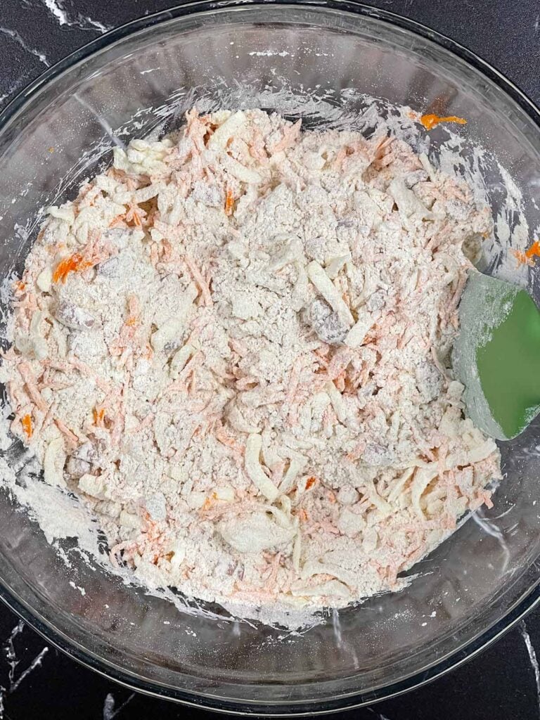 Shredded carrots and chopped pecans tossed in the dry ingredients.