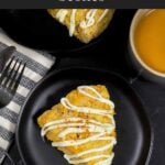 Carrot cake scone on a dark plate garnished with ground nutmeg and cinnamon.