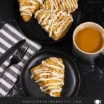 Carrot cake scone on a dark plate garnished with ground nutmeg and cinnamon.