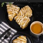 Carrot cake scone on a dark plate garnished with ground nutmeg and cinnamon.