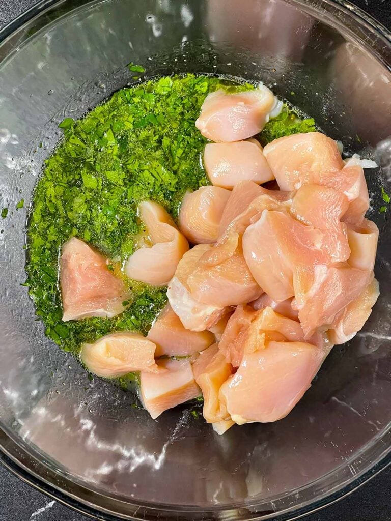 Chicken added to a marinade.