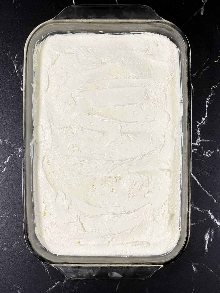 Cream cheese mixture spread over the crust of the lush.
