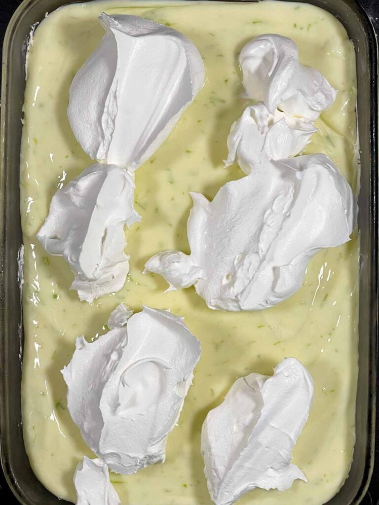 Whipped topping dolloped over the Key Lime layer.