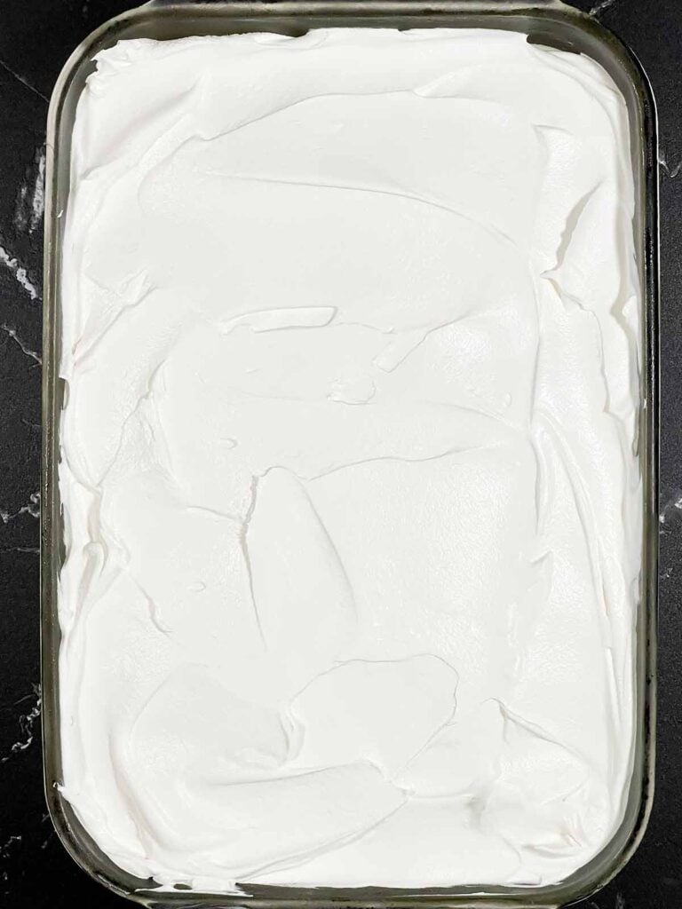 Whipped topping spread over the Key Lime layer of the lush.