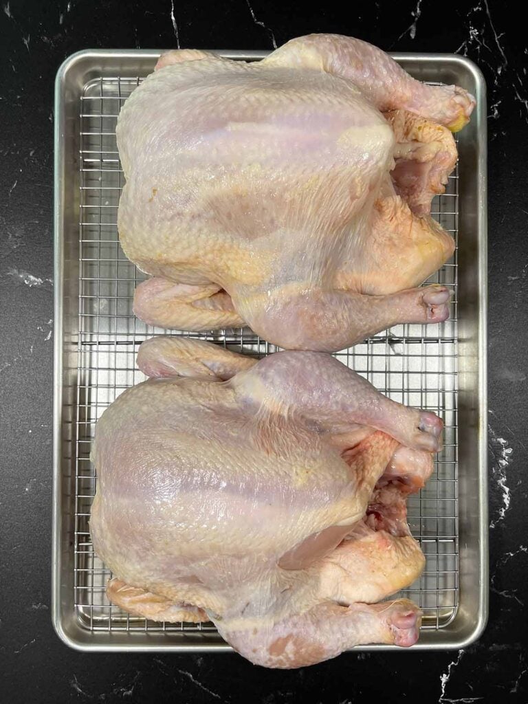 Dry brined chicken on a wire rack.