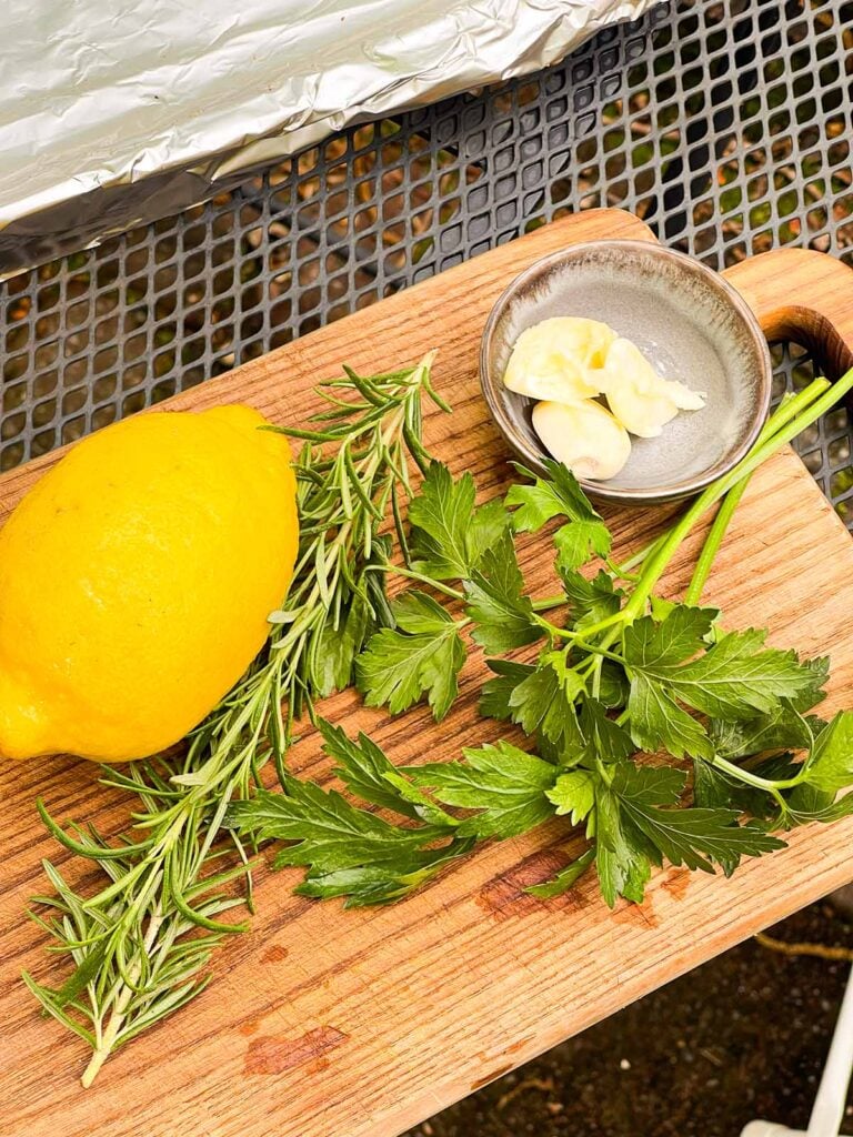 Some herbs on a cutting board.