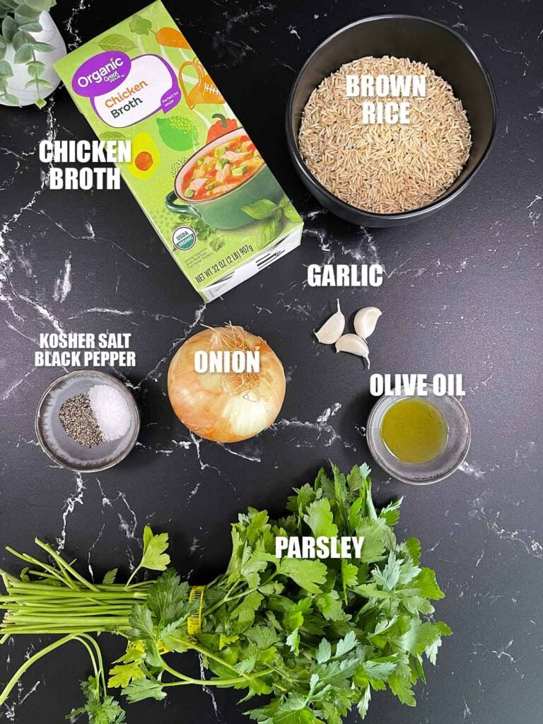 Ingredients for baked brown rice arranged on a countertop.