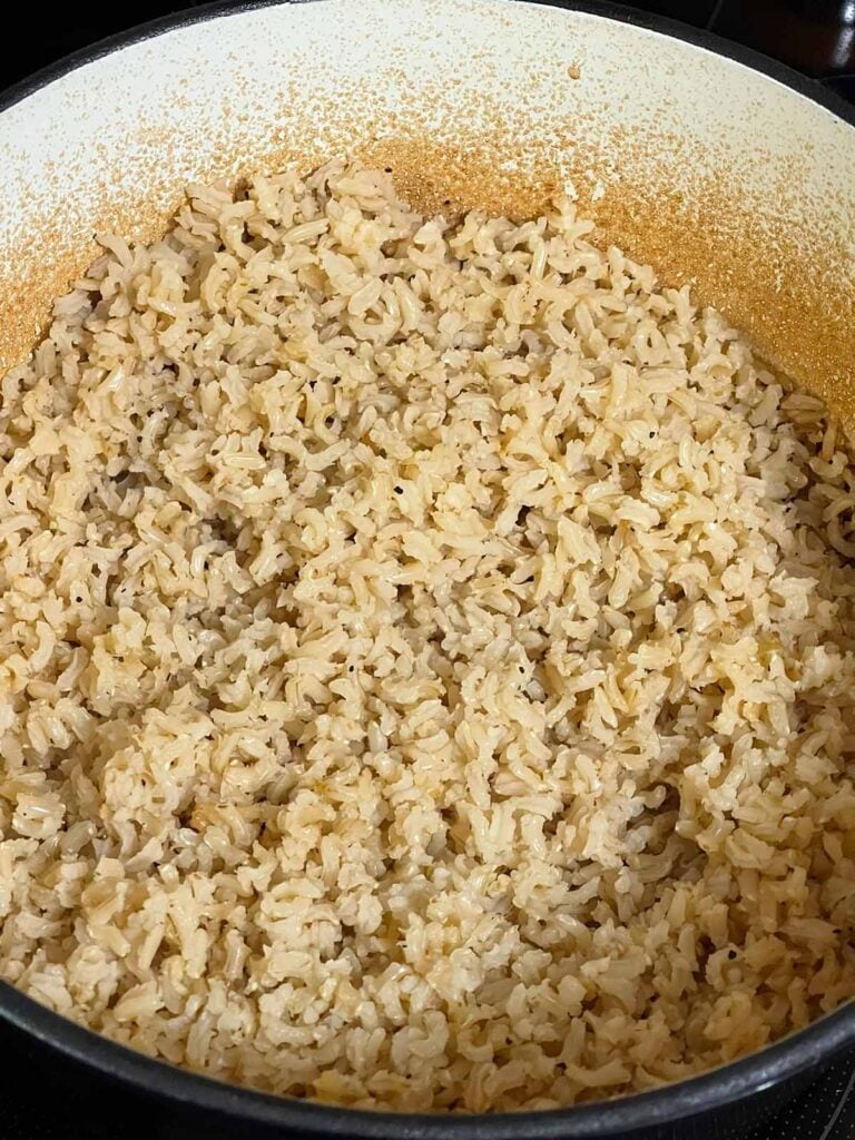 Fluffy baked brown rice fluffed with a fork.