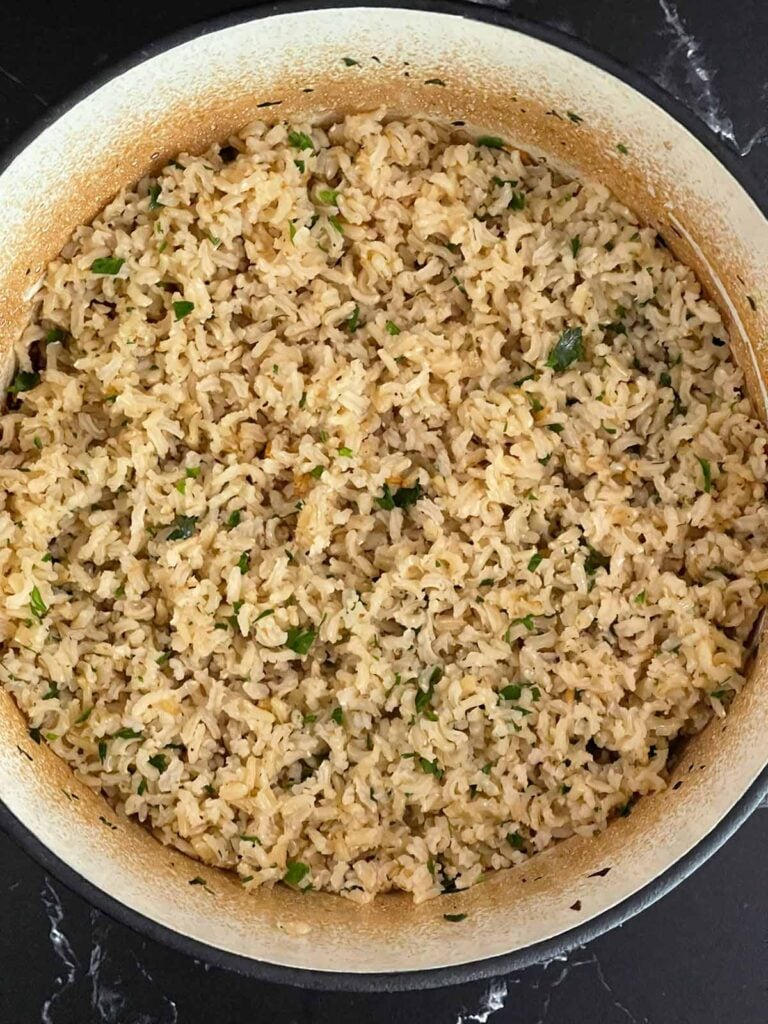 Fresh parsley stirred into the baked brown rice.