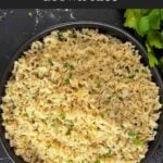 Baked brown rice served in a dark bowl.