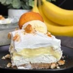 A serving of banana pudding lush on a dark plate.
