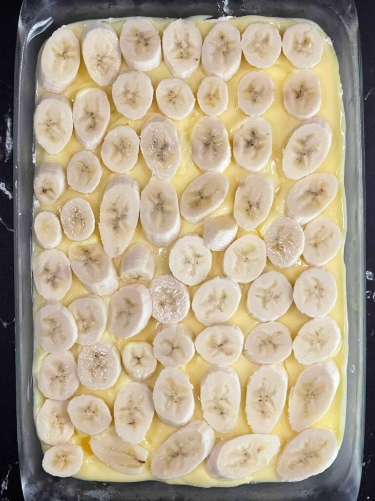 Sliced bananas layered over the banana pudding.