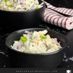 Classic Coleslaw served in a black bowl with shredded cabbage, carrots, and green onions in a creamy tangy dressing.