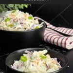 Bowl of Classic Coleslaw with crisp cabbage, carrots, and green onions in a creamy homemade dressing.