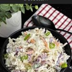 Bowl of Classic Coleslaw with crisp cabbage, carrots, and green onions in a creamy homemade dressing.