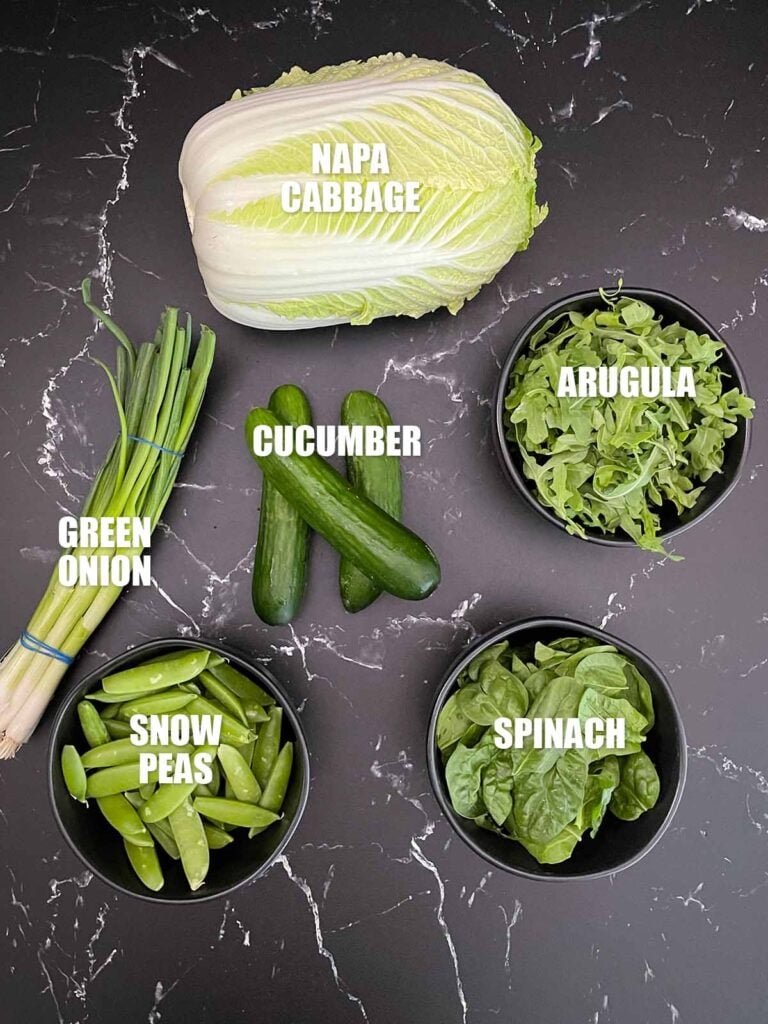 Green Goddess Salad recipe ingredients on a dark surface.